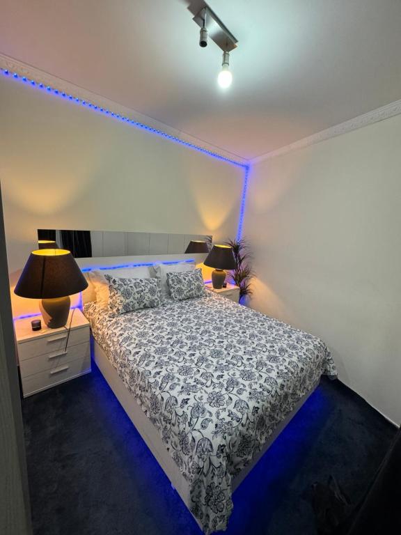 a bedroom with a bed with blue lights on it at Rise Lodge in Brussels