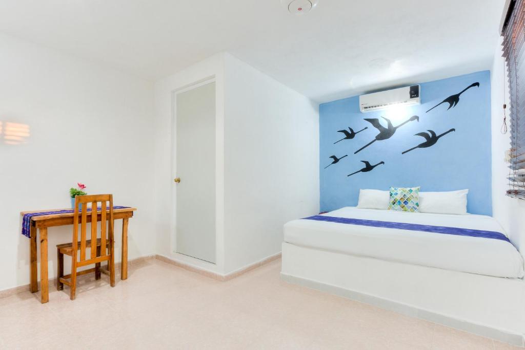 Postel nebo postele na pokoji v ubytování HOTEL LAS COLORADAS