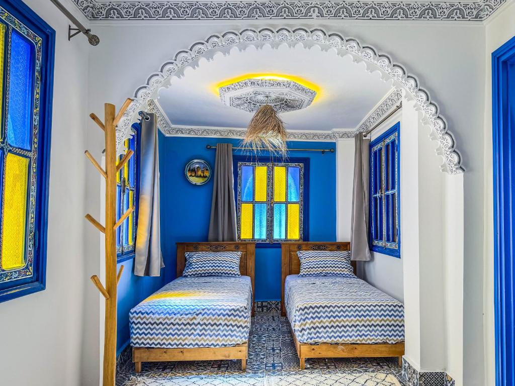 Postel nebo postele na pokoji v ubytování Dar Sharif Tanger