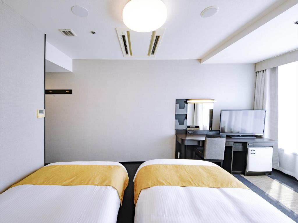 Postel nebo postele na pokoji v ubytování APA Hotel Tottori Ekimae Minami
