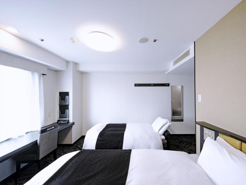 Postel nebo postele na pokoji v ubytování APA Hotel Tottori Ekimae Minami