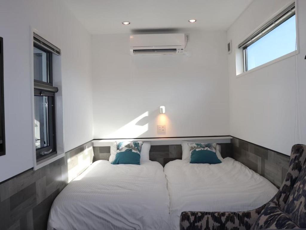 Postel nebo postele na pokoji v ubytování GLORY ISLAND OKINAWA Yabusachi Resort