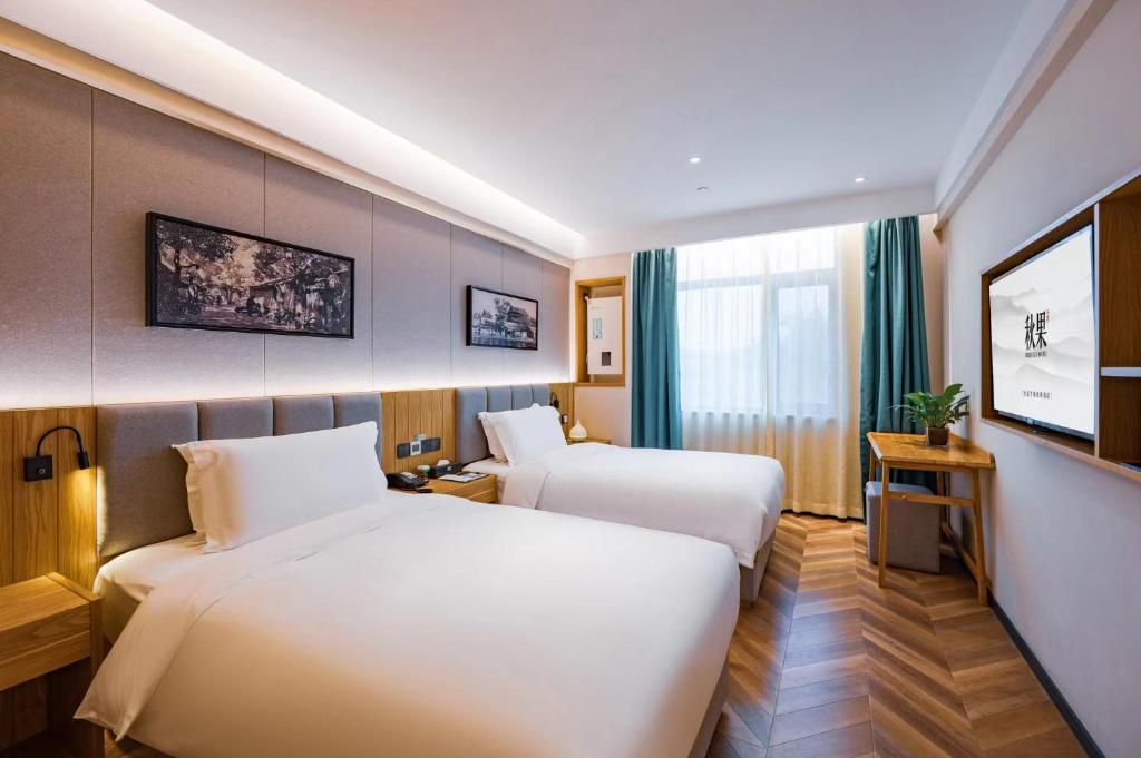 Postel nebo postele na pokoji v ubytování Qiu Guo Hotel Xidan Financial Street Beijing