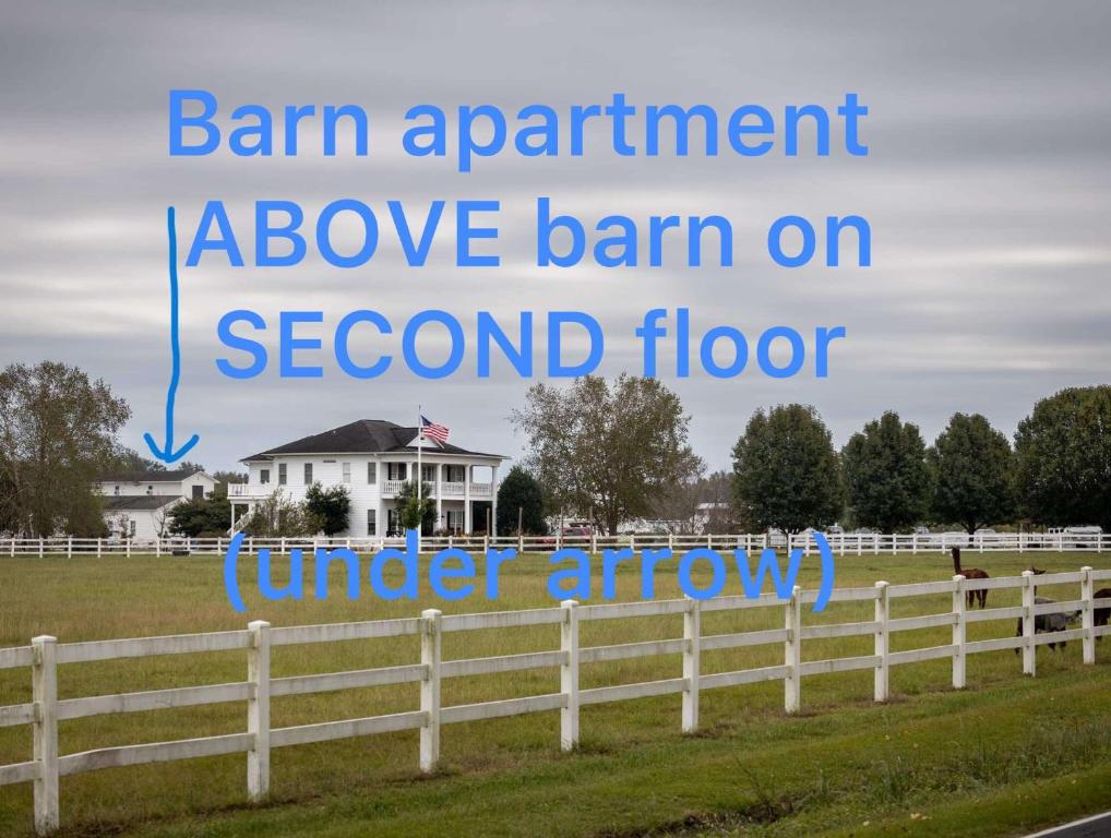 a sign that reads barn apartment above barn on second floor at The Barn Apartment at Parkton Place in Hope Mills