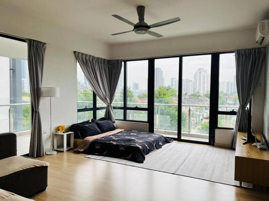 a bedroom with a bed and a ceiling fan at Huge City View balcony - Netflix in Subang Jaya