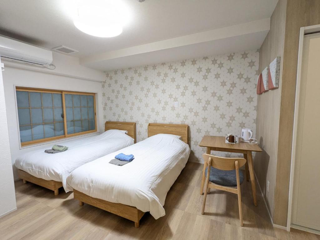 Postel nebo postele na pokoji v ubytování Nikko Beans Hotel