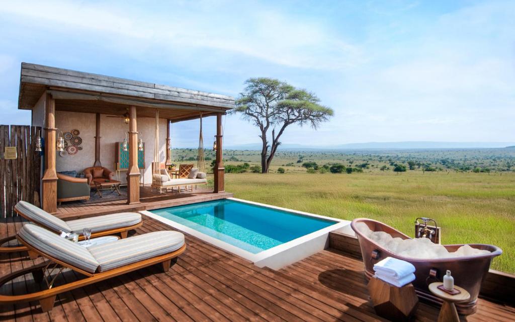 a swimming pool on a deck with a hot tub at One Nature Mara River in Serengeti National Park