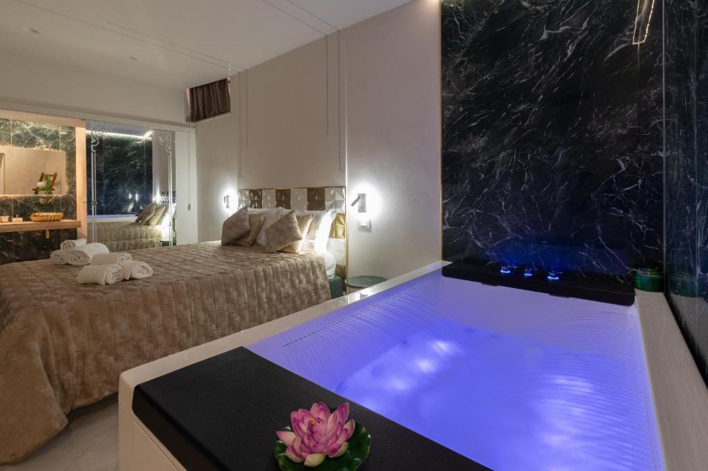a bathroom with a tub in a bedroom with a bed at TaoZen Apartments in Taormina