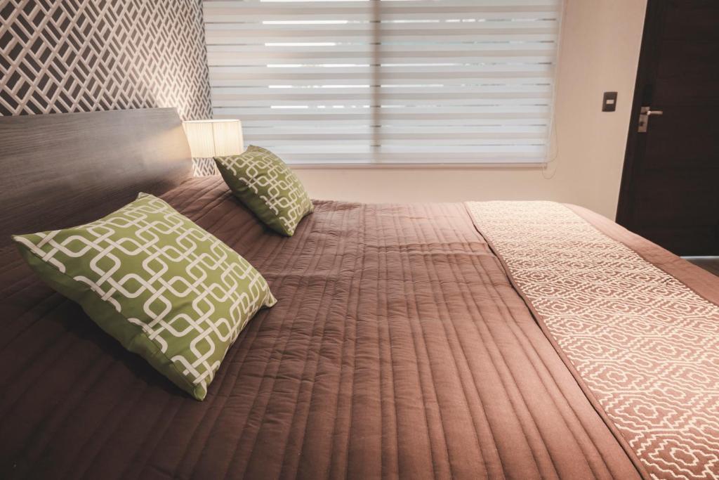 Postel nebo postele na pokoji v ubytování Hotel Platino Expo Guadalajara