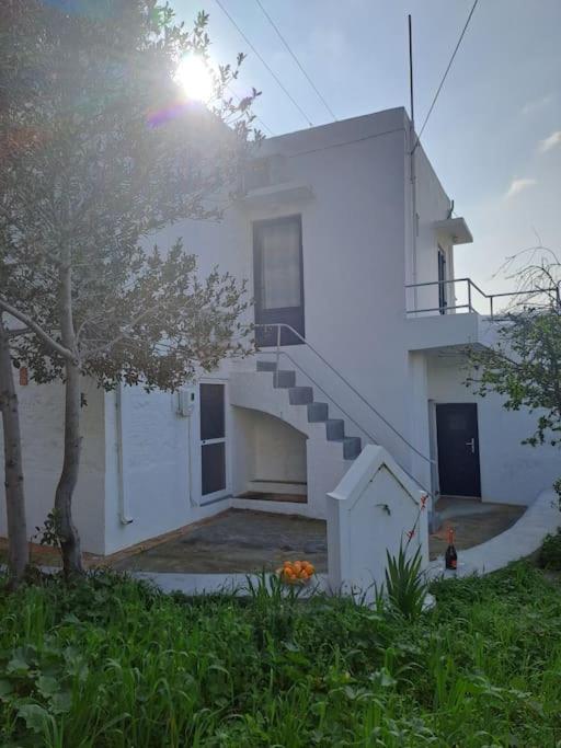 a white house with a staircase in front of it at Ο Παράδεισος της Αφροδίτης in Kalymnos