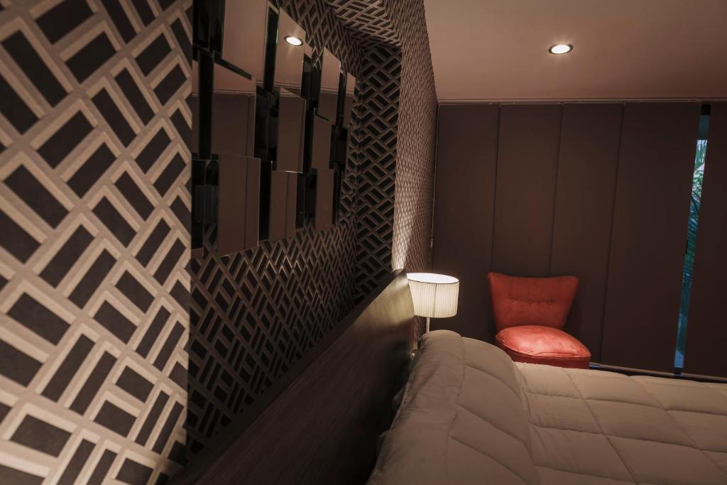 Postel nebo postele na pokoji v ubytování Hotel Platino Expo Guadalajara