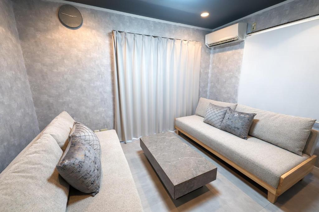 a living room with a couch and a table at 2LDK,75 square meters,6pp,Projector,QuietHome,Shinagawa Area in Tokyo