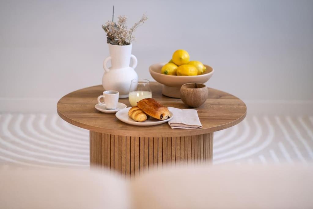 - une table avec un bol de fruits et une assiette de nourriture dans l'établissement Le Cocon - Proche Gare Châteaucreux-, à Saint-Étienne