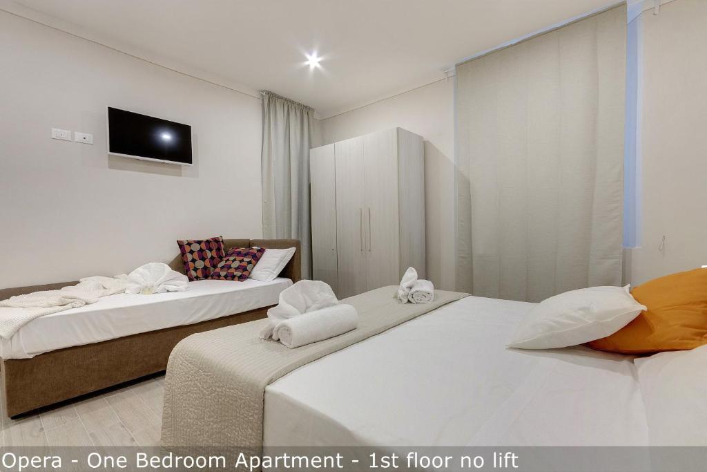 Posteľ alebo postele v izbe v ubytovaní Opera - Sinfonia - Minuetto - Melody Apartments by Mamo Florence