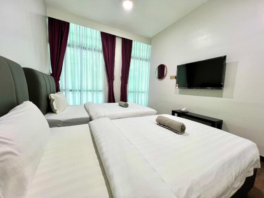 Postel nebo postele na pokoji v ubytování Margo Hotel Kota Kinabalu