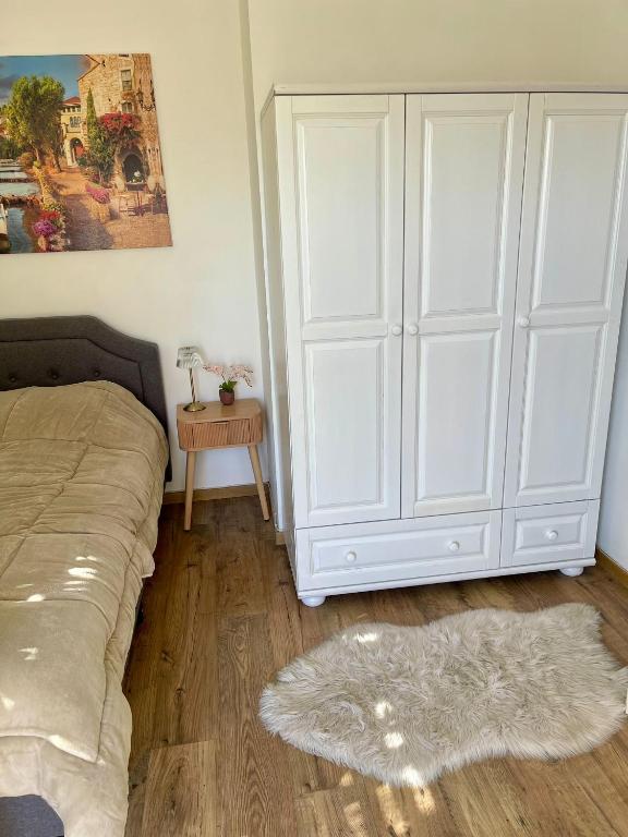 a bedroom with a bed and a large white cabinet at Suits יחידת נופש מתוקה באילת in Eilat