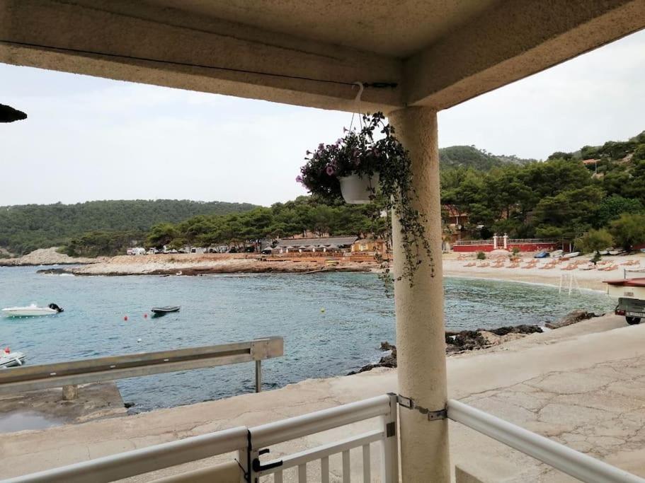 a balcony with a view of a beach and the ocean at Studio apartment Milna, Hvar Buratovic in Hvar