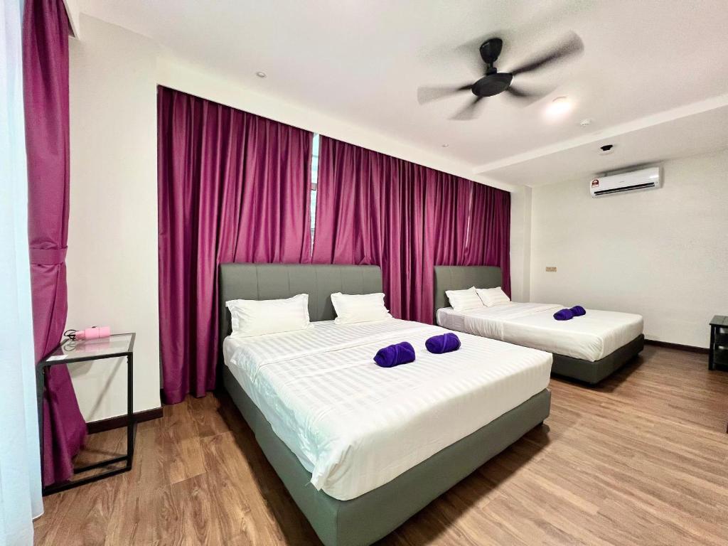 Postel nebo postele na pokoji v ubytování Margo Hotel Kota Kinabalu