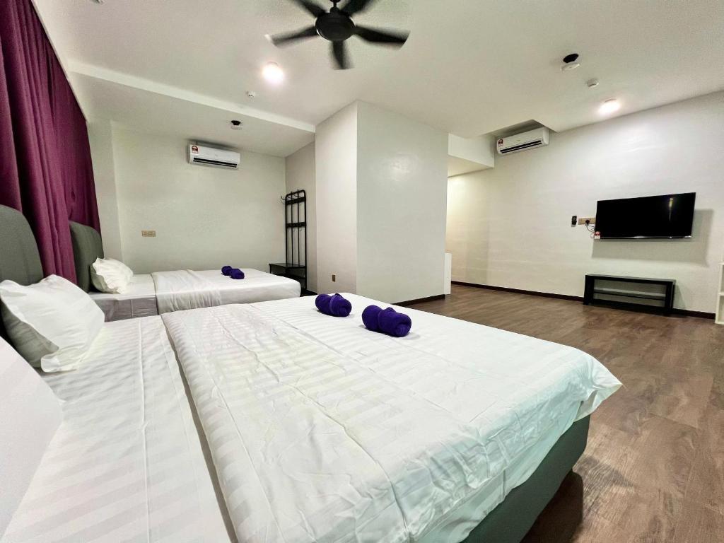 Postel nebo postele na pokoji v ubytování Margo Hotel Kota Kinabalu