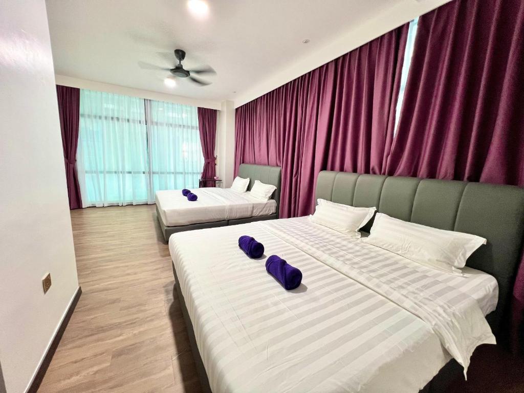 Postel nebo postele na pokoji v ubytování Margo Hotel Kota Kinabalu