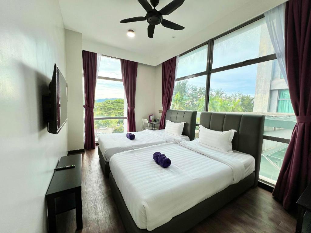 Postel nebo postele na pokoji v ubytování Margo Hotel Kota Kinabalu