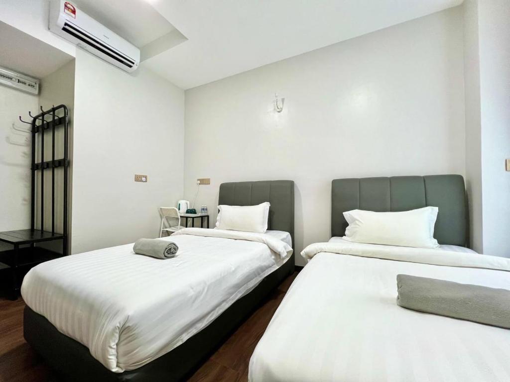 Postel nebo postele na pokoji v ubytování Margo Hotel Kota Kinabalu