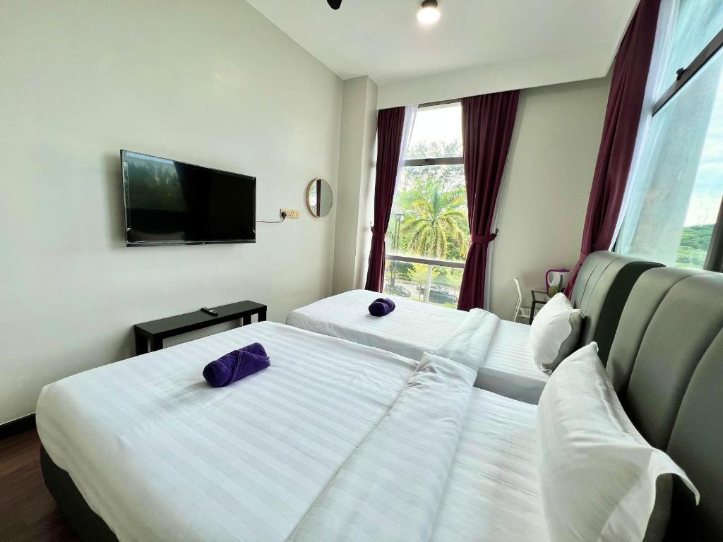 Postel nebo postele na pokoji v ubytování Margo Hotel Kota Kinabalu