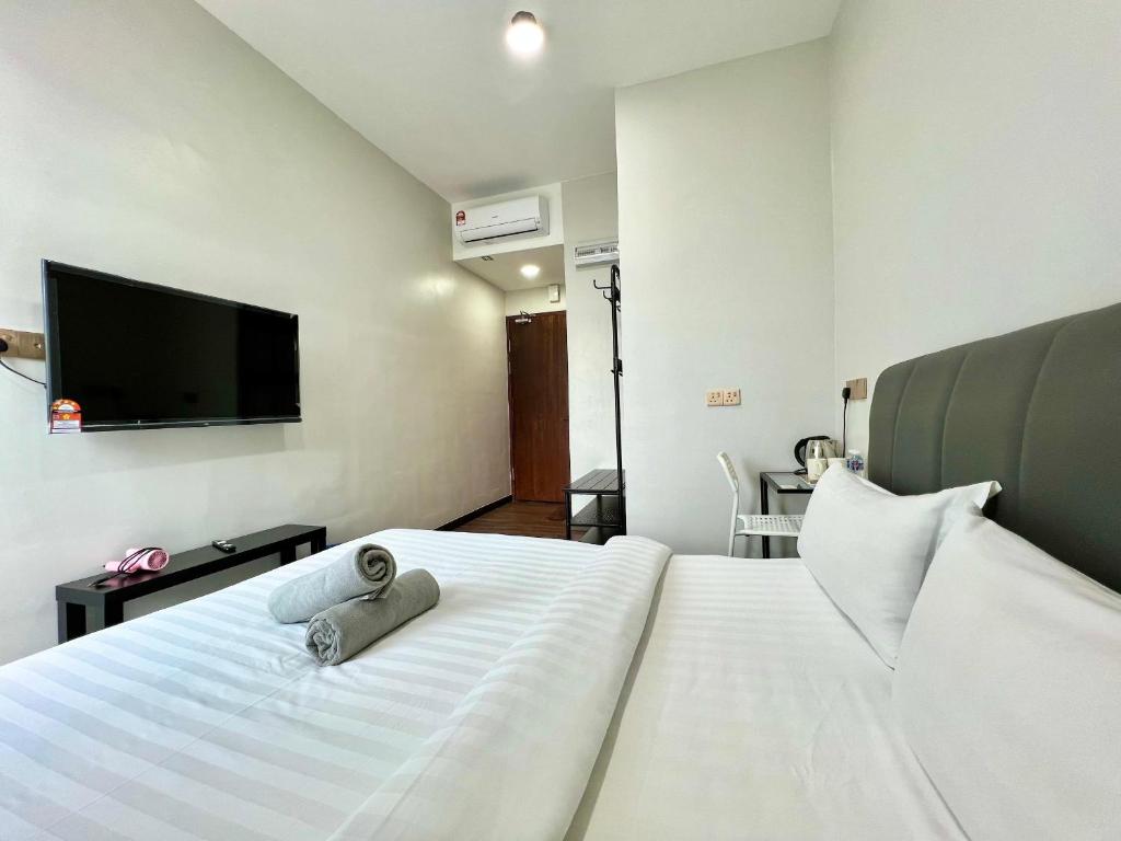 Postel nebo postele na pokoji v ubytování Margo Hotel Kota Kinabalu