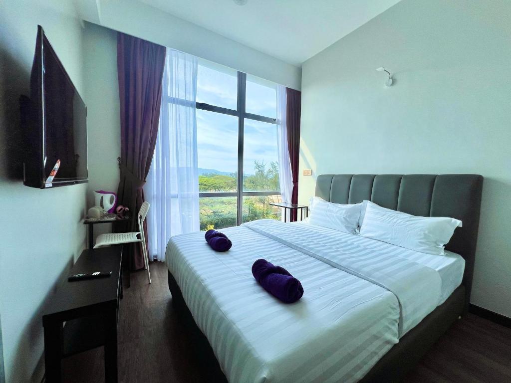 Postel nebo postele na pokoji v ubytování Margo Hotel Kota Kinabalu