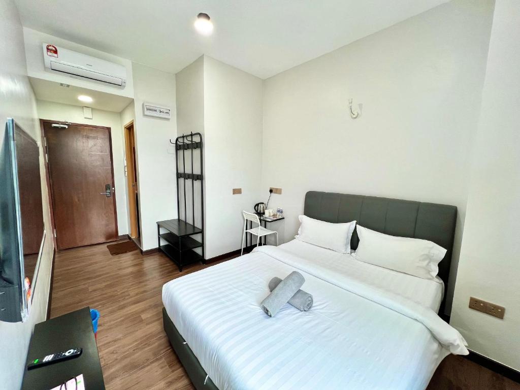 Postel nebo postele na pokoji v ubytování Margo Hotel Kota Kinabalu
