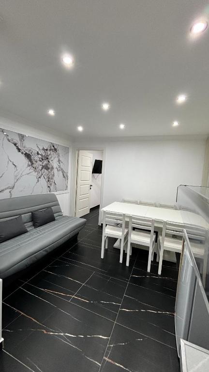 a living room with a couch and a table at Chaleureux t1 Aiguebelle in Randens