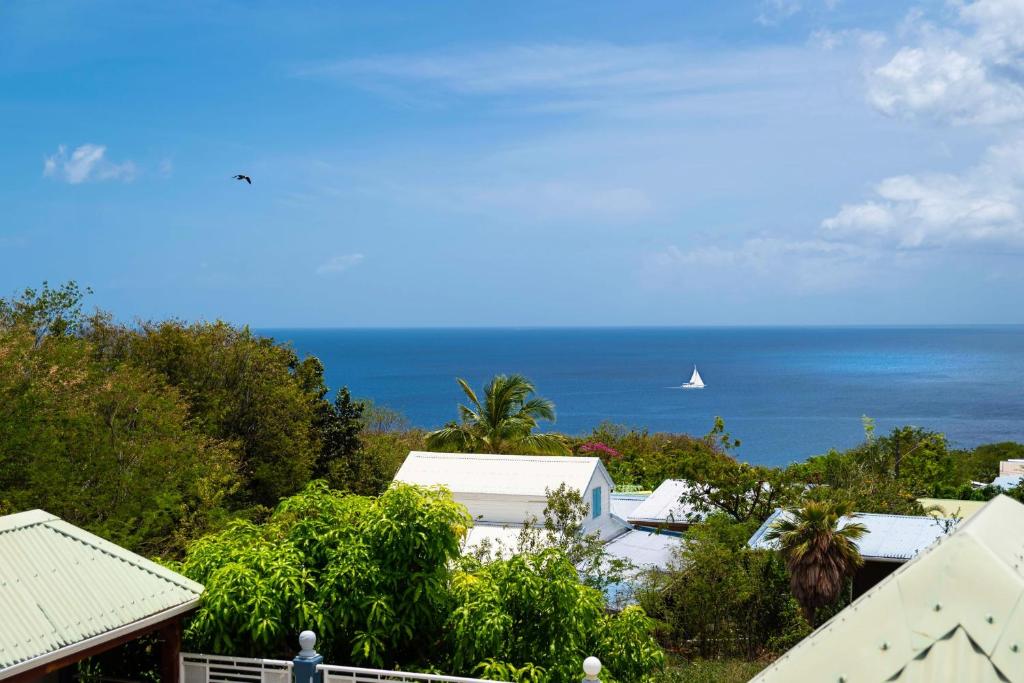 a view of the ocean from a house at Villa Sun and Sea in Deshaies