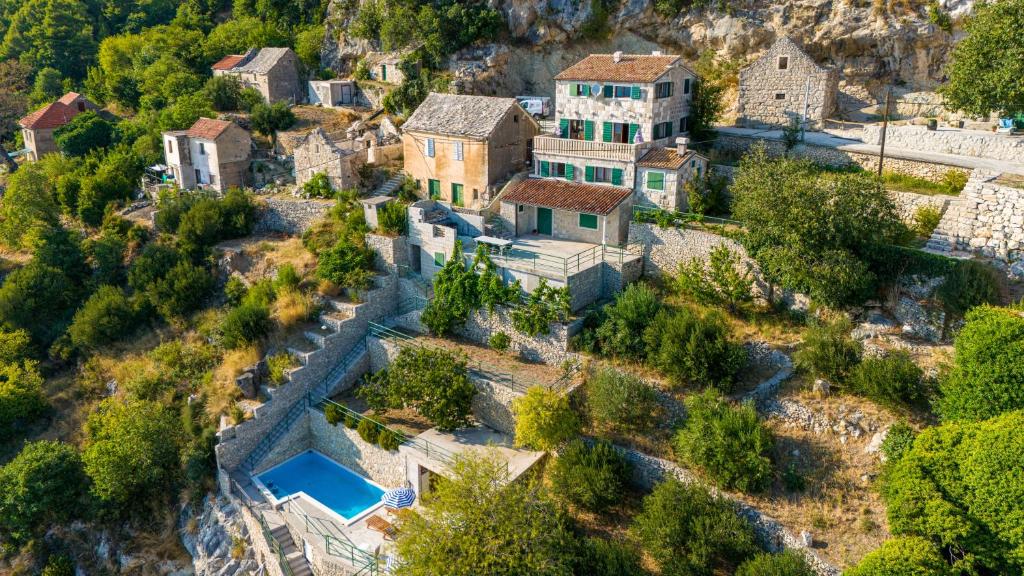 an aerial view of a house on a hill at Apartments with pool Maraska in Brela