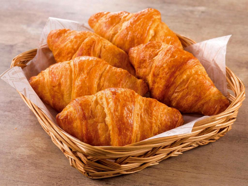 a basket filled with croissants on top of a table at Comfort Hotel Nara in Nara