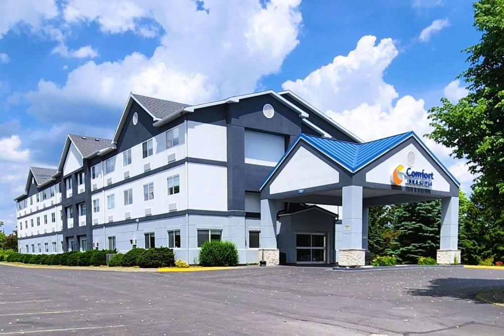 a large white building with a sign on it at Comfort Inn & Suites Liverpool - Syracuse in Liverpool