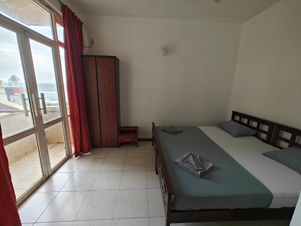 Postel nebo postele na pokoji v ubytování Palmyrah Residencies
