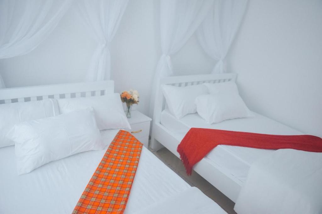 Postel nebo postele na pokoji v ubytování Saruni Homes
