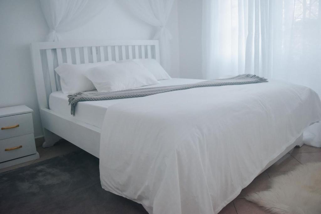 Postel nebo postele na pokoji v ubytování Saruni Homes
