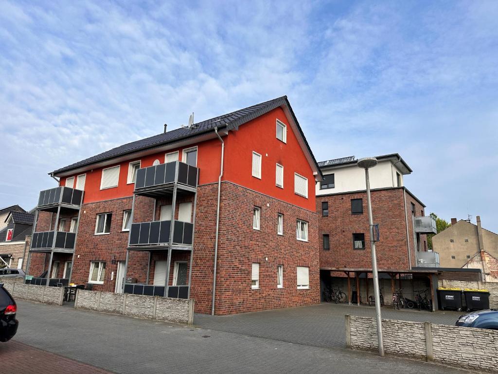 a red brick building on the side of a street at AM Apartment in Gronau