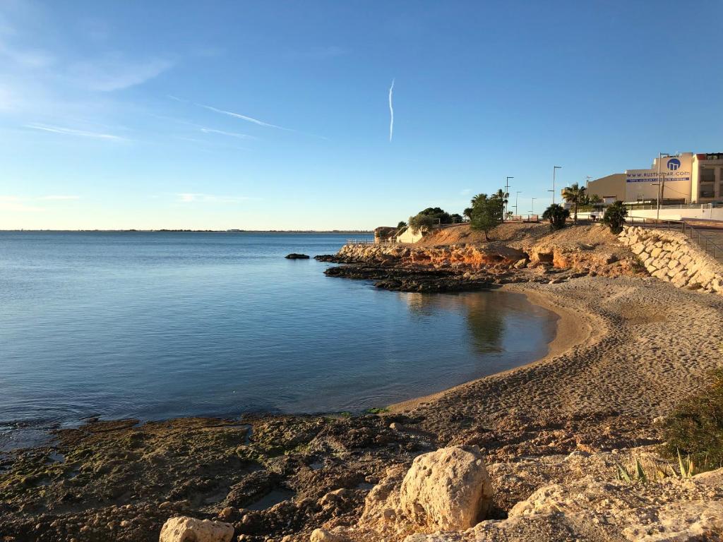 a view of a body of water with a rocky shore at Apartament L'Ampolla MONICA a 50m del mar amb parking in L'Ampolla