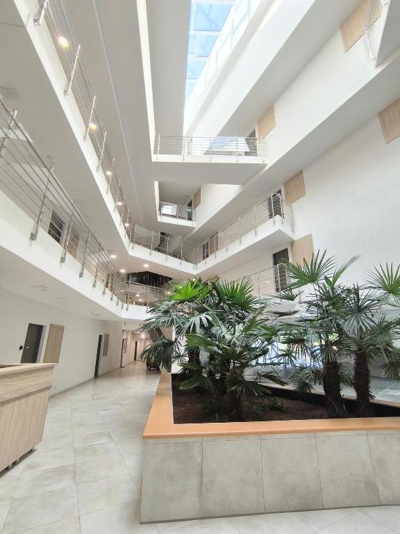 an office with plants in the middle of a building at Sunshine Residence Boutique Apartment in Hévíz