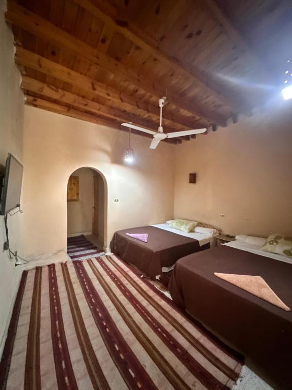 Postel nebo postele na pokoji v ubytování Nour El Waha Hotel