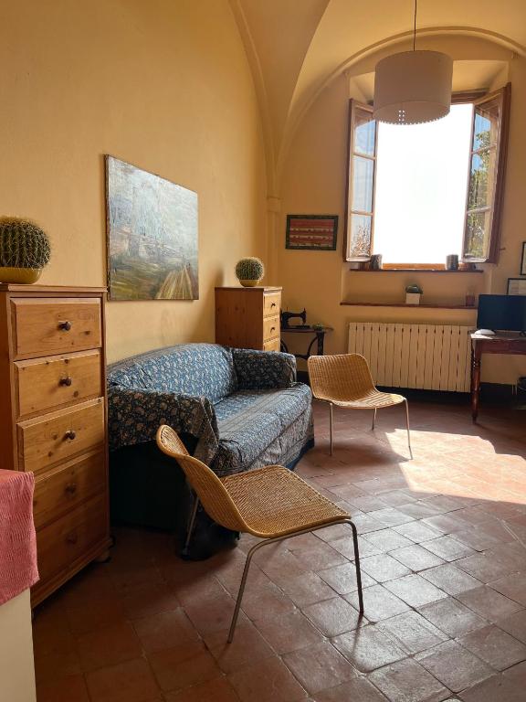 a bedroom with a bed and a dresser at Azienda Agricola Fabbrica Di San Martino in Lucca