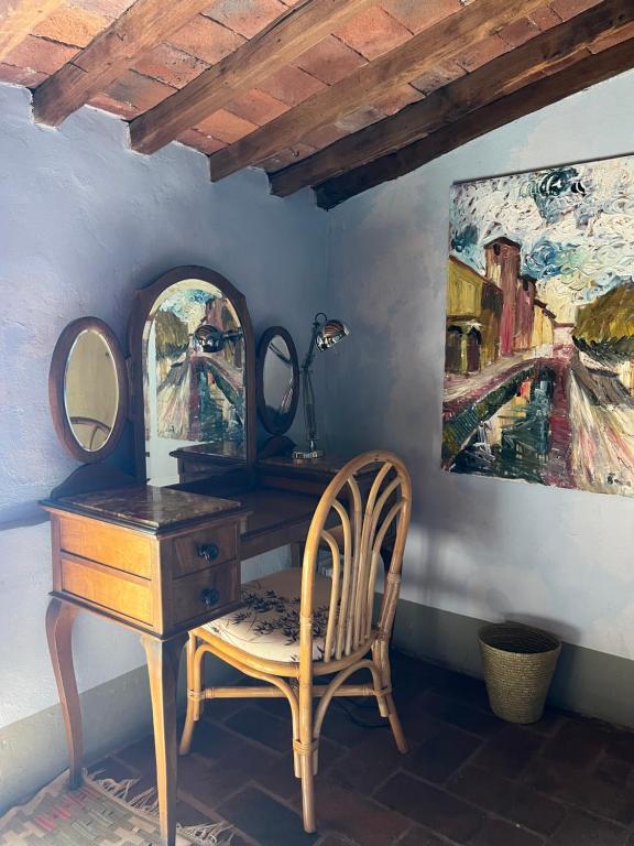 a dressing table with a chair and a mirror at Azienda Agricola Fabbrica Di San Martino in Lucca