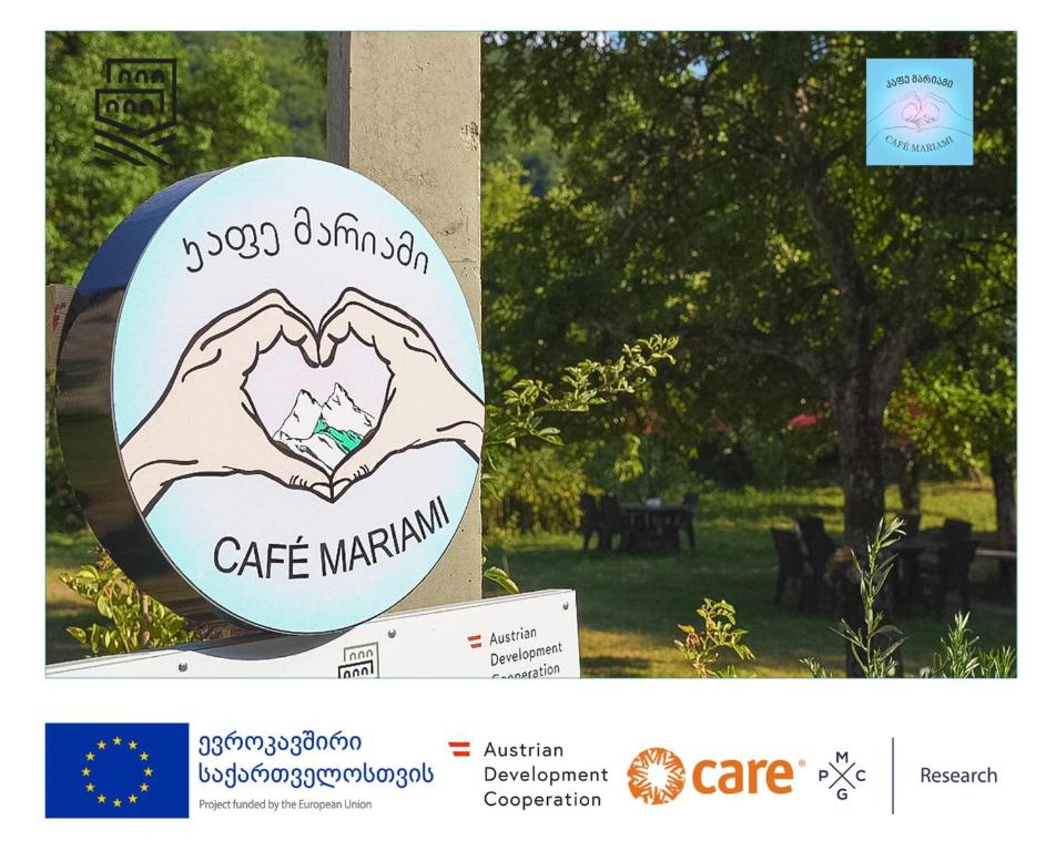 a sign with two hands making a heart at Guest House Mariami in Ushkhvanari