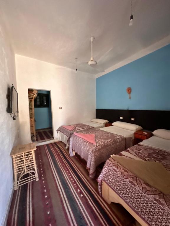 Postel nebo postele na pokoji v ubytování Nour El Waha Hotel