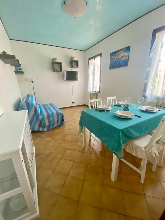 a dining room with a blue table and chairs at Venice Nora's House in Mestre