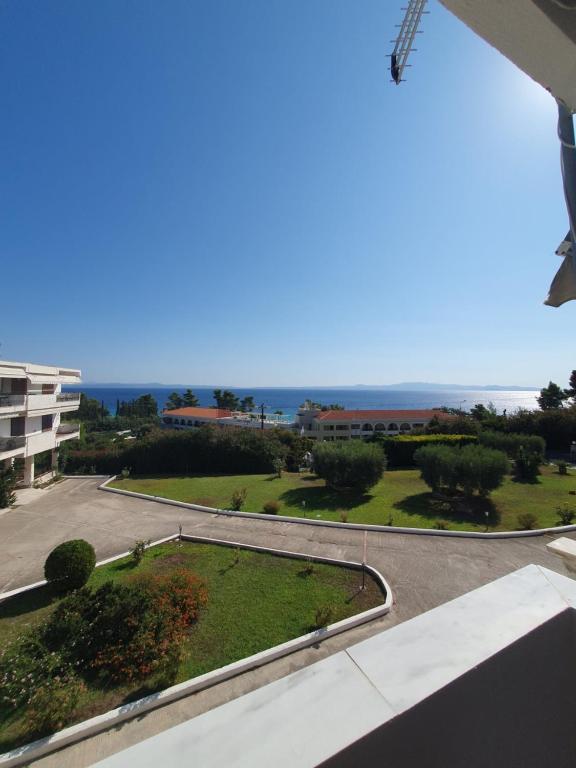 a view of a parking lot with the ocean in the background at Paralia Homes Ocean Postcard in Kriopigi