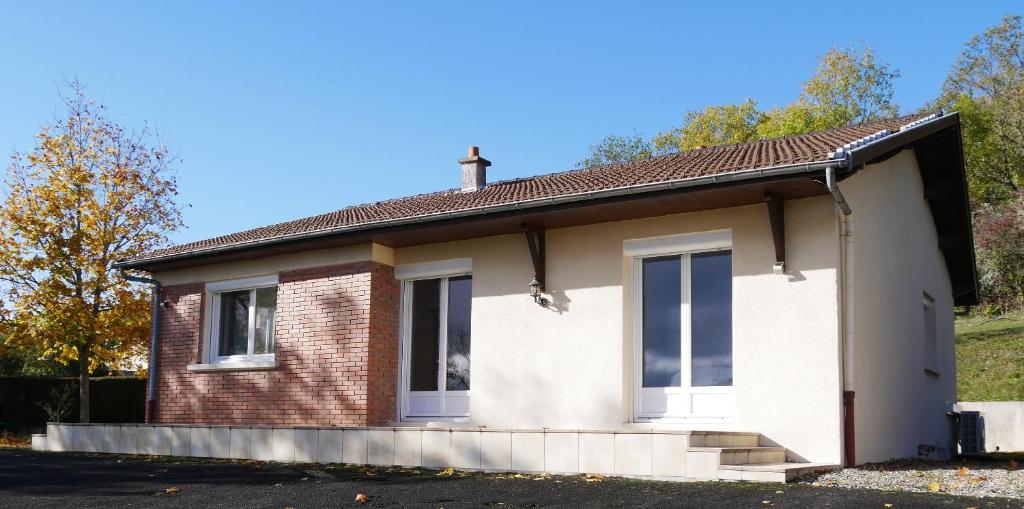 a small brick house with a cross on the roof at Villa Horizon in Châtel-Guyon