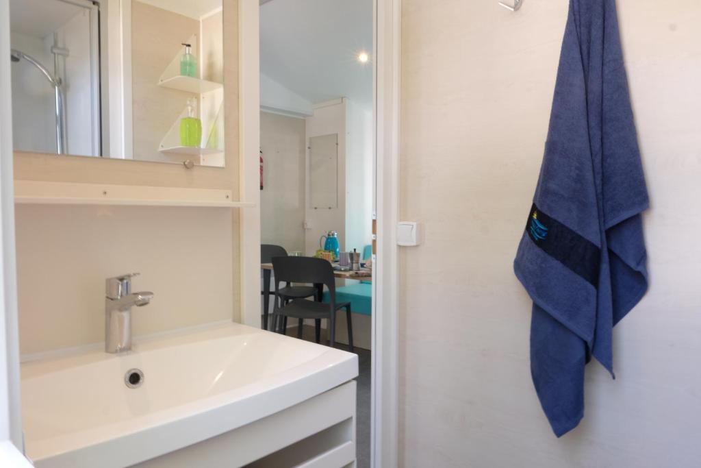 łazienka z umywalką i lustrem w obiekcie Happy Camp Mobile Homes in Camping Cisano San Vito w mieście Bardolino